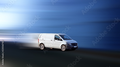Servicefahrzeug unterwegs in dynamischer Fahrt vor blauem Hintergrund mit Bewegungsunschärfe  photo