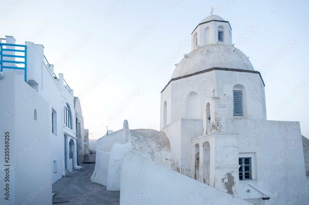 Typical street in Thira on the island of Santorini, Greece. Travel, Cruises, Architecture, Landscapes. Greek street and Orthodox church in the background