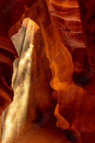 A sunray shining in the upper antelope cave enhance by sand particle, Arizona, USA