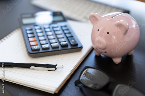 Vászonkép piggybank And Calculator On Desk business document calculator counting money