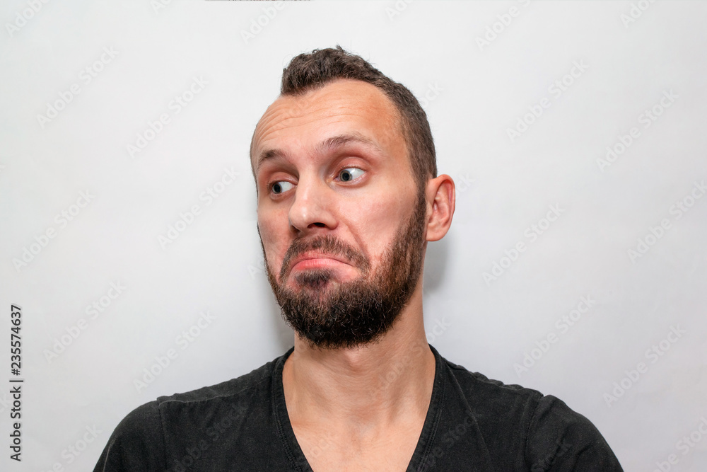 Fototapeta premium portrait of a young bearded guy with a surprised and astonished face