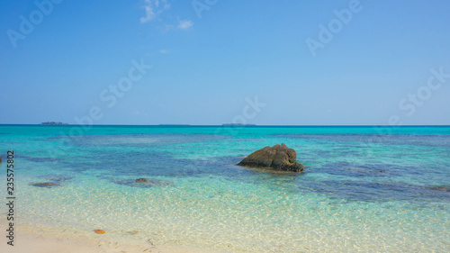 stone water on the beach with very blue and clear sky on karimun jawa island
