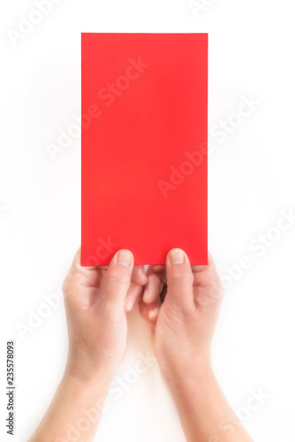 A close-up of a red envelope (red card) in a white background in one hand