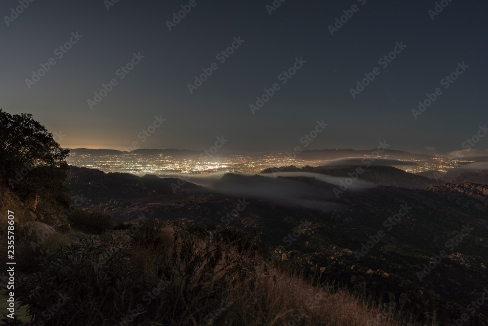 Hilltop view of fog pouring over the Santa Susana Pass in the San Fernando Valley area of Los Angeles, California.  Shot from Rocky Peak Mountain Park near Simi Valley.  
