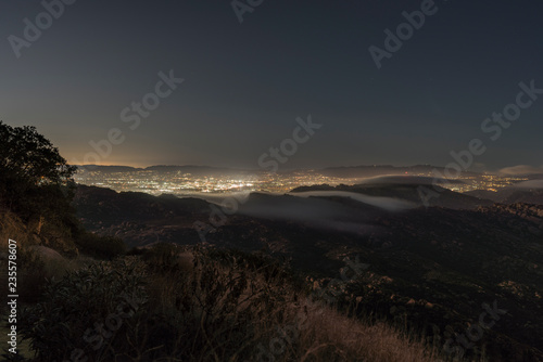 Hilltop view of fog pouring over the Santa Susana Pass in the San Fernando Valley area of Los Angeles, California. Shot from Rocky Peak Mountain Park near Simi Valley. 