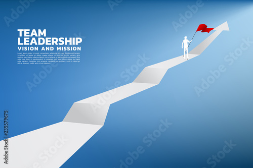 silhouette of businessman with the red flag standing on the top of graph. Business Concept of Goal, Mission, Vision, Success in Career path.