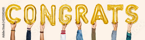 Yellow gold alphabet balloons forming the word congrats photo