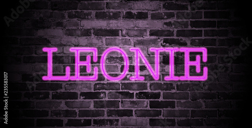 first name Leonie in pink neon on brick wall