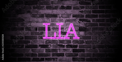first name Lia in pink neon on brick wall photo
