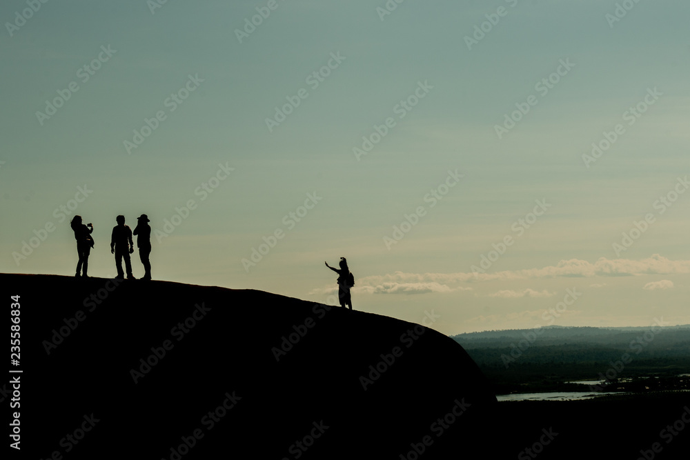 Silhouette group of friend take photo on the top of mountain. Travel gank happiness.