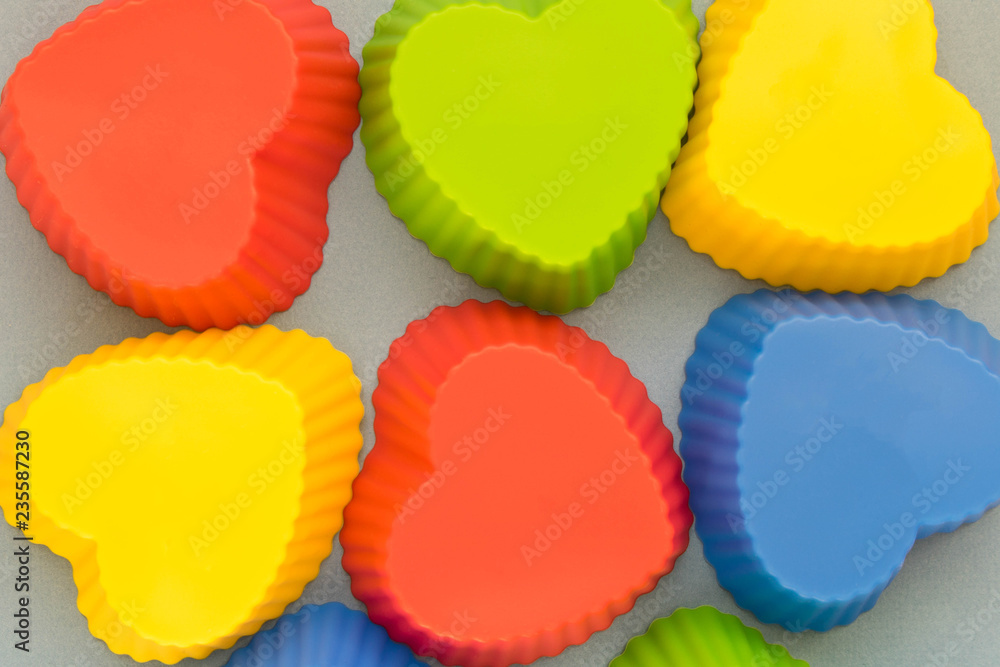 Multi-colored baking molds on a light background Multi-colored baking molds on a light background