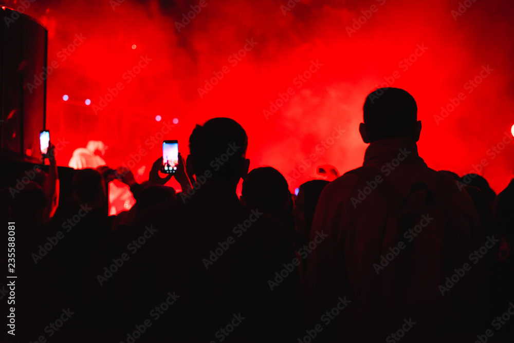 The backs of the Spectators at the concert backlight lumiere