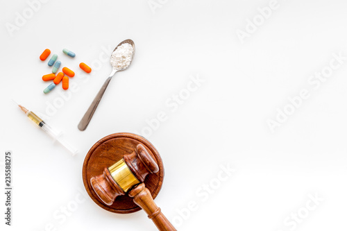 Drugs addiction, arrest for drugs. Pills, spoon with powder, syringe on white background top view copy space