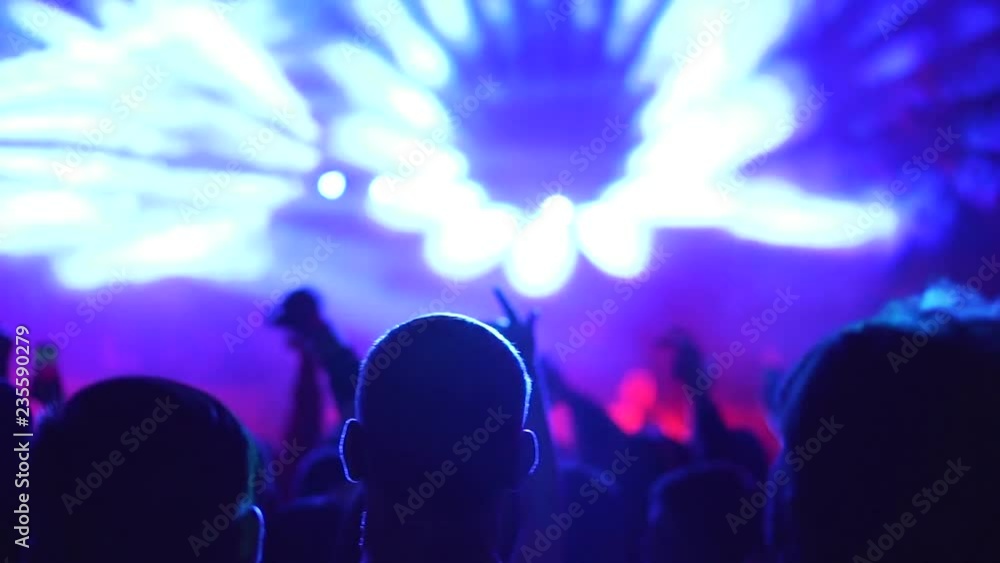 The backs of the Spectators at the concert backlight lumiere The backs of the Spectators at the concert backlight lumiere