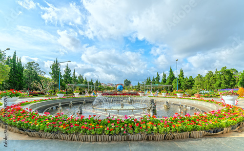 Flower carpet in the park with many flowers covered the fountain in the middle attracts tourists to the flower garden in Dalat city, Vietnam