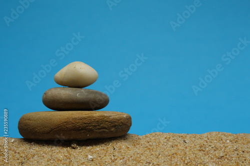 A cairn or Zen pile of pebbles on sea sand.