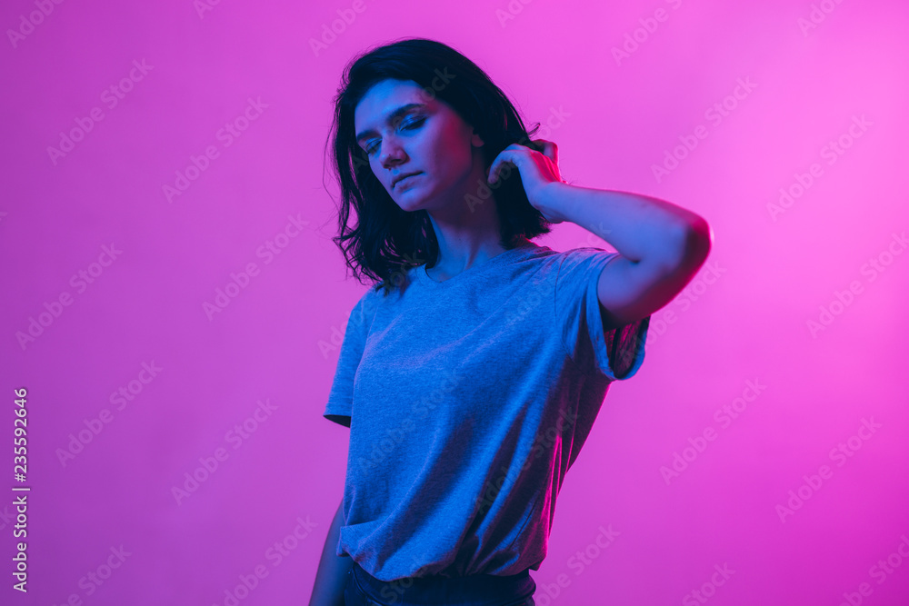 Young woman in pink blue neon lights. Creative colorful portrait Young woman in pink blue neon lights. Creative colorful portrait