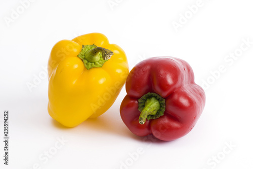 Red and yellow sweet peppers on a white background.