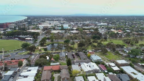 Aerial pan over houses and Mornington Peninsula coastline in Frankston, Victoria, Australia