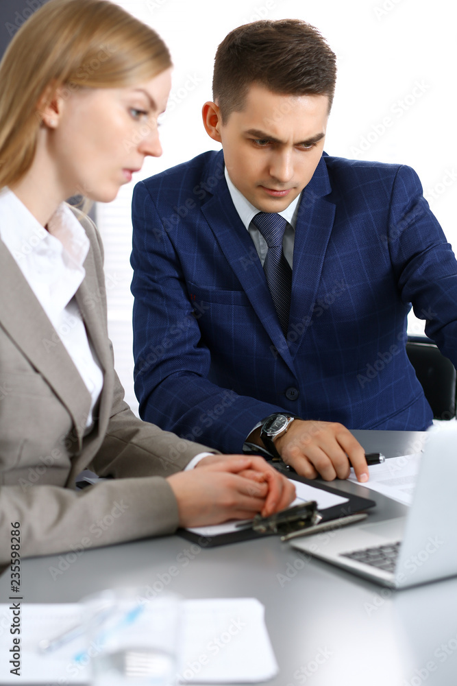 Business people using laptop pc while discussing project in office. Successful meeting and negotiation concepts Business people using laptop pc while discussing project in office. Successful meeting and negotiation concepts