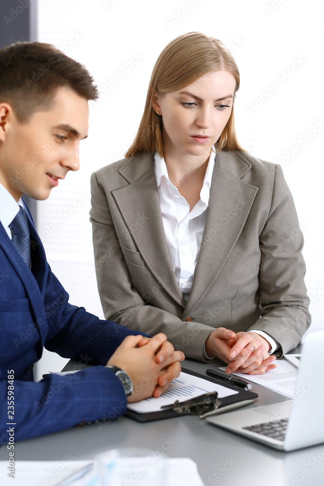 Business people using laptop pc while discussing project in office. Successful meeting and negotiation concepts Business people using laptop pc while discussing project in office. Successful meeting and negotiation concepts