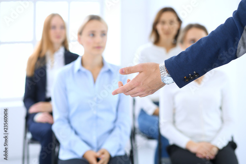 Business man making presentation to group of people. Speaker delivering a seminar to his colleagues or business training. Teamwork and coaching concept