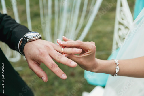 wedding rings on hands of groom and bride © Dmitry