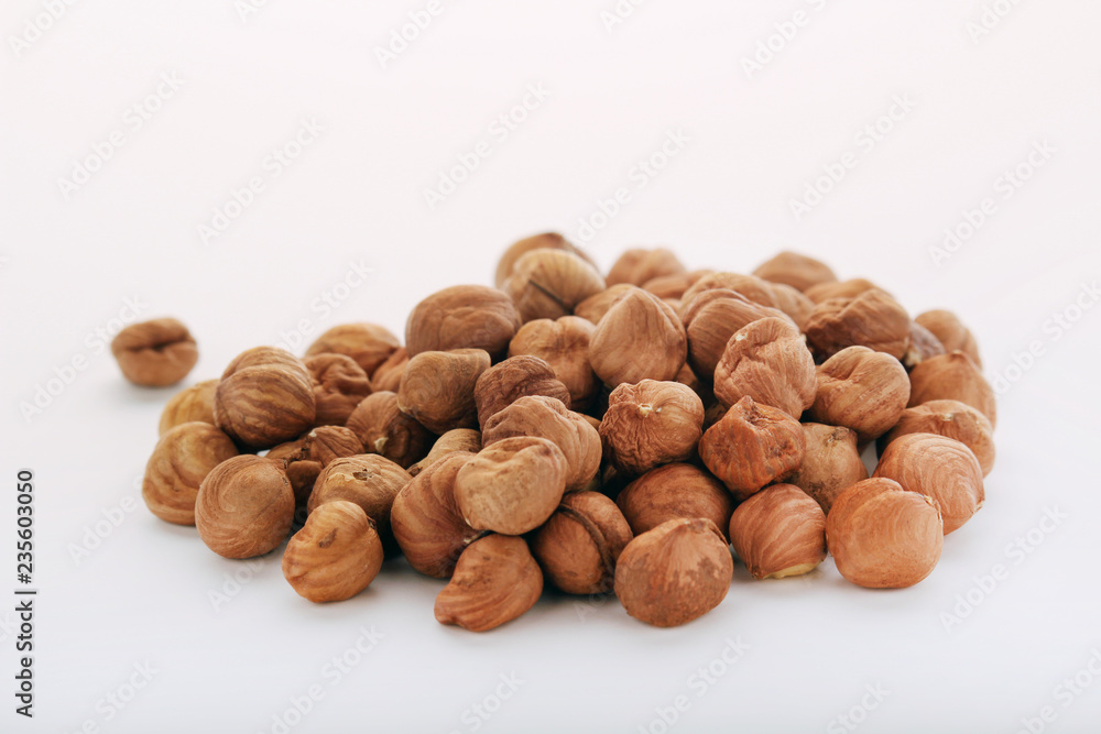 A pile of hazelnuts at white background A pile of hazelnuts at white background