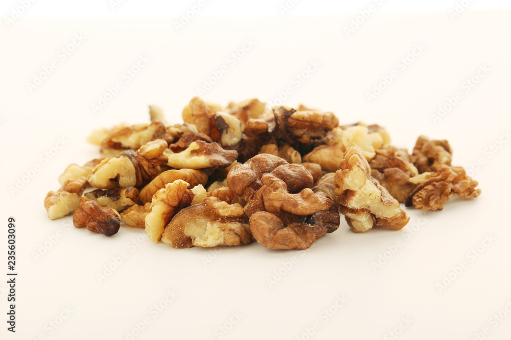 A pile of peeled walnuts at white background A pile of peeled walnuts at white background