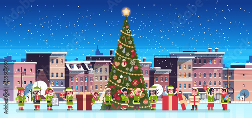 mix race elves group near decorated fir tree city building houses night winter street cityscape merry christmas happy new year concept flat horizontal banner vector illustration