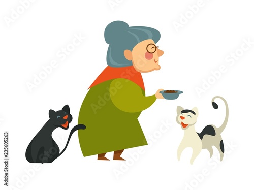 Smiling granny holding a bowl with food for her two cats