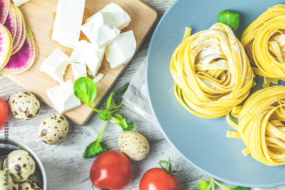 Raw homemade Italian typical pasta linguine noodles on plate Raw homemade Italian typical pasta linguine noodles on plate