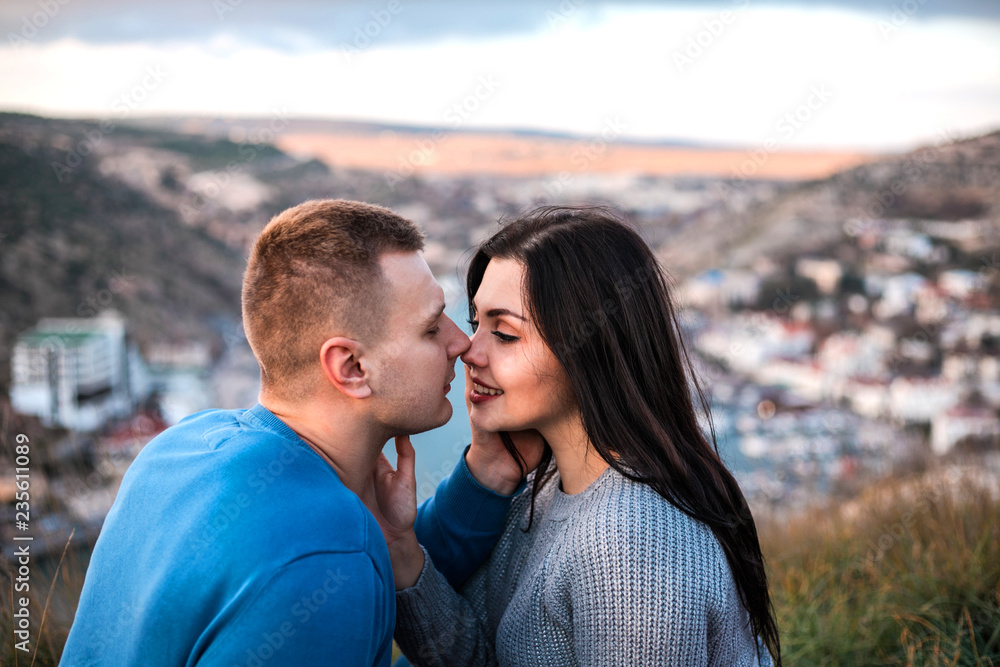 Loving couple is about kiss at sunset. Loving couple is about kiss at sunset.