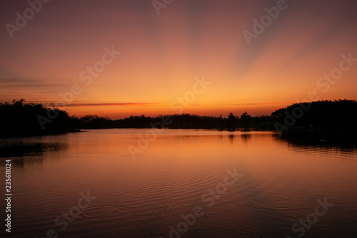 Landscape of sunset and twilight sky with the lake in foreground