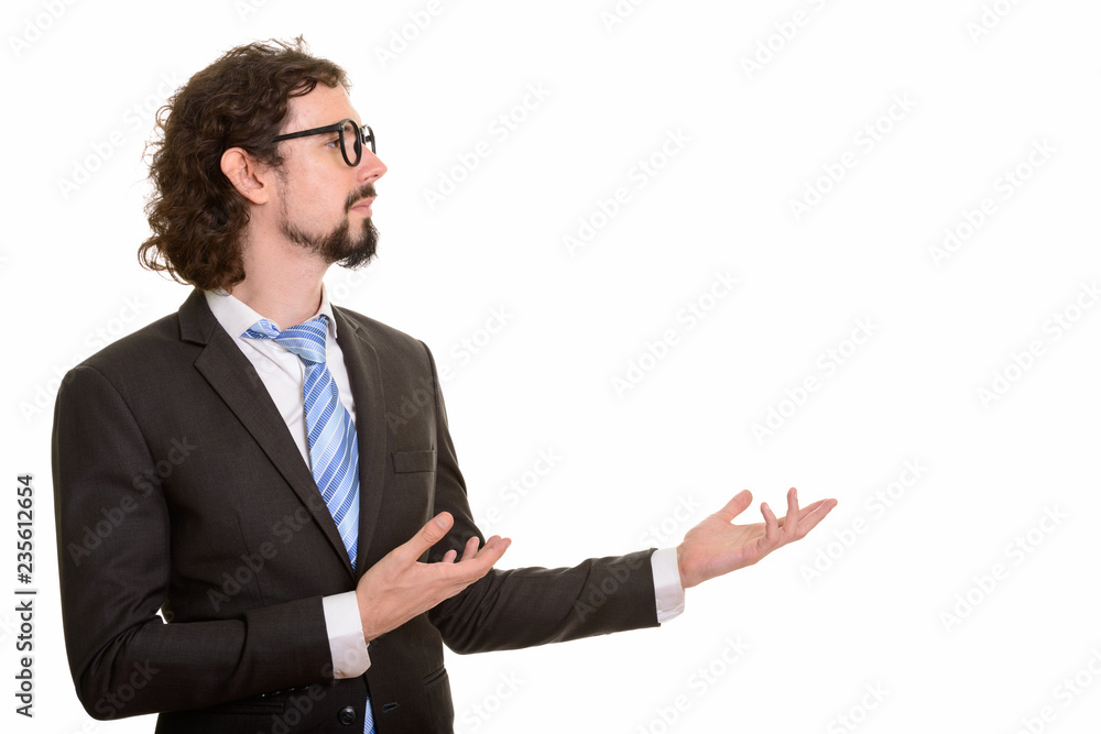 Profile view of handsome Caucasian businessman showing something Profile view of handsome Caucasian businessman showing something