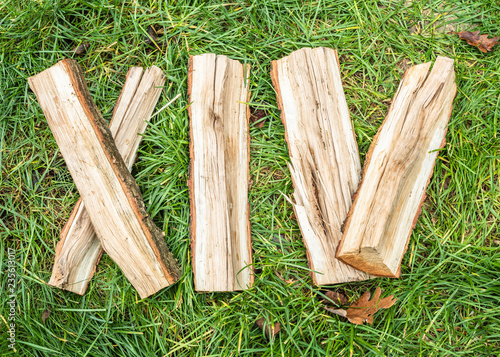 Roman numeral. Roman numerals made from oak. Old wood numbers. Old roman antique alphabet number on green grass background. Number fourteen.