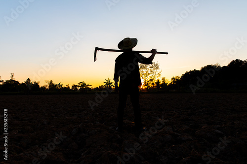 Farmer working on field at sunset outdoor