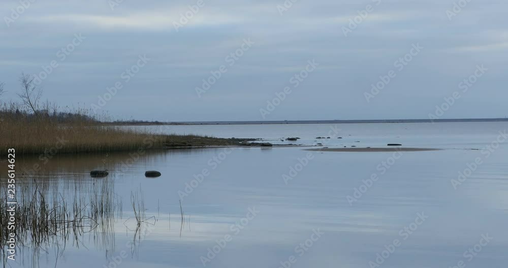 Blue lake in autumn, peace and quiet, clouds reflected on the surface of the water Blue lake in autumn, peace and quiet, clouds reflected on the surface of the water
