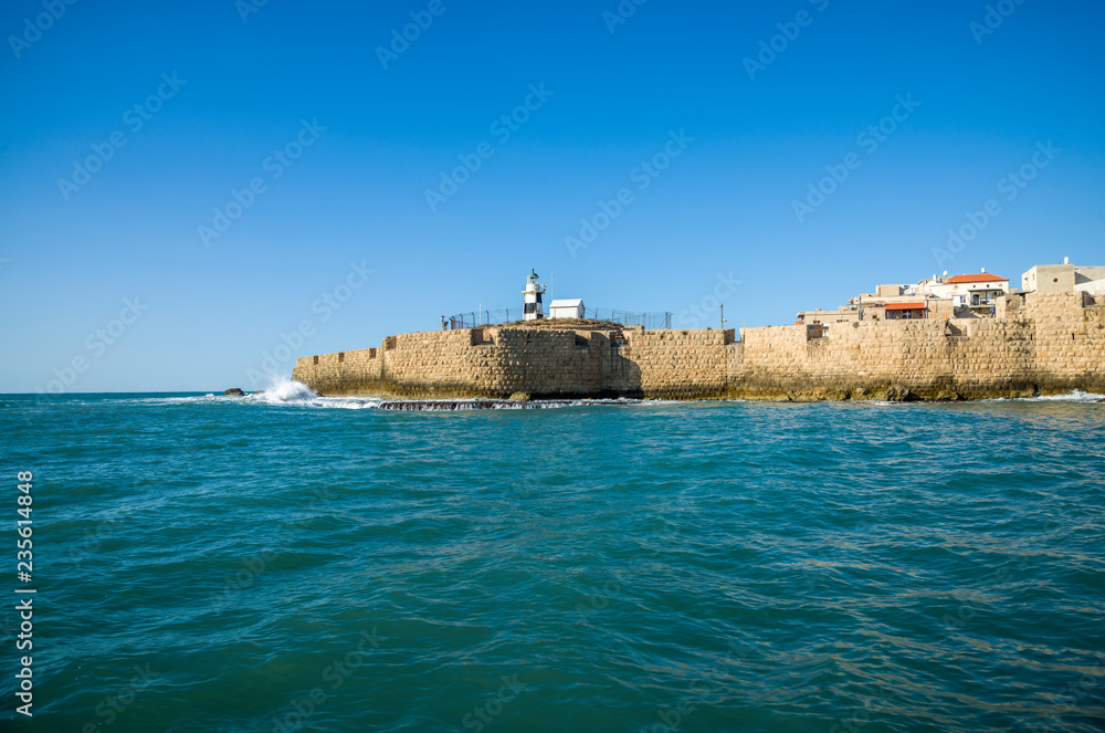 Acre's Lighthouse and sea wall in the old city of Acre, Israel