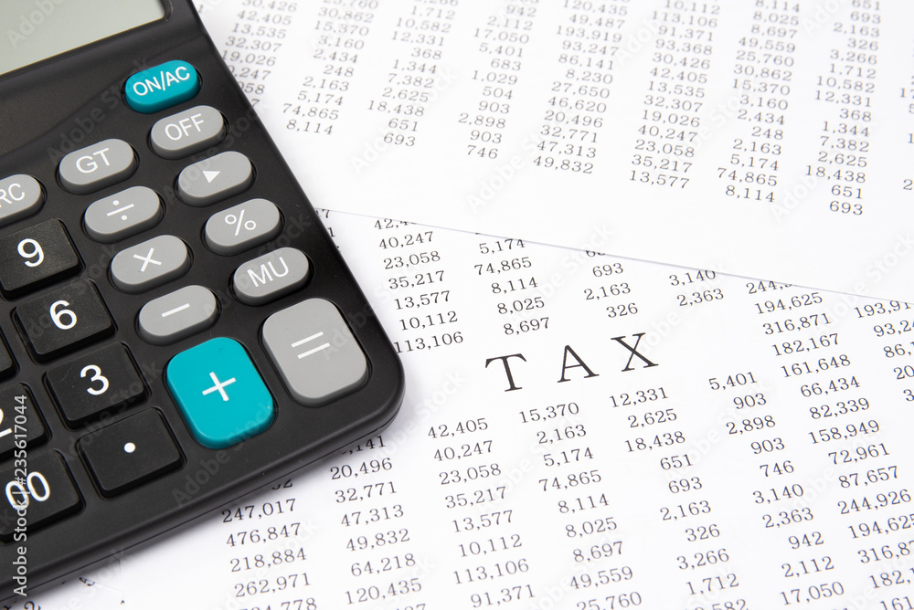 A calculator on financial chart, financial concept. A calculator on financial chart, financial concept.