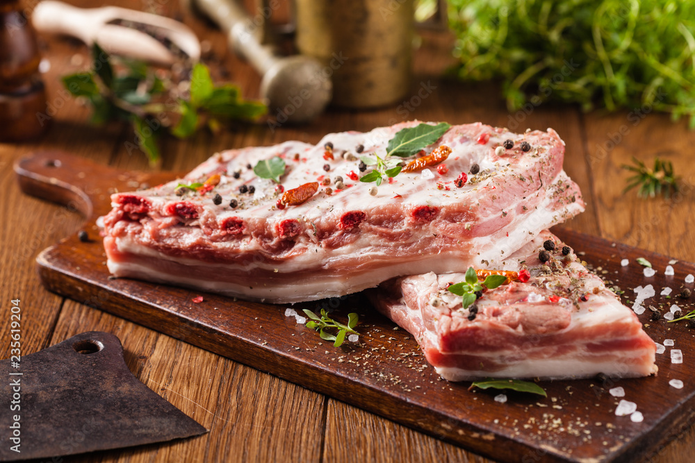 Raw pork ribs, on a plate sprinkled with spices. Raw pork ribs, on a plate sprinkled with spices.