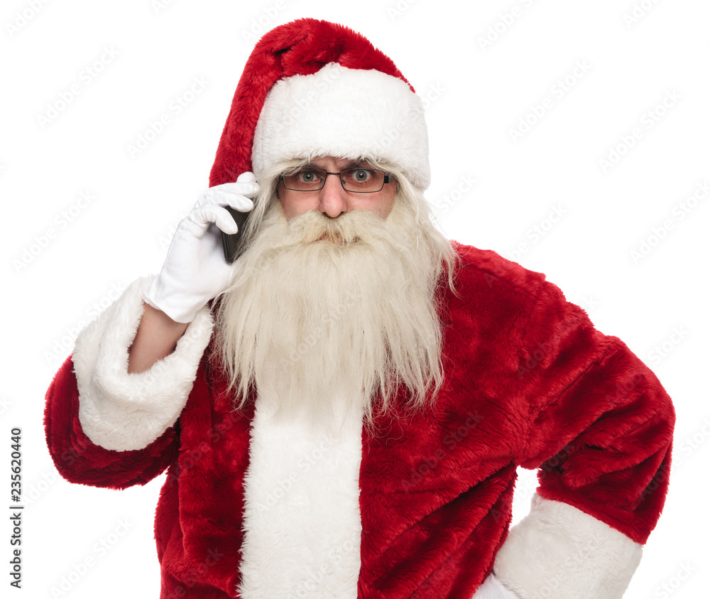 portrait of angry santa claus speaking on the phone