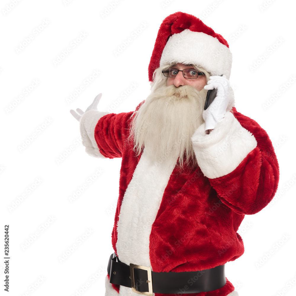 santa claus talking on the phone makes and inviting gesture santa claus talking on the phone makes and inviting gesture