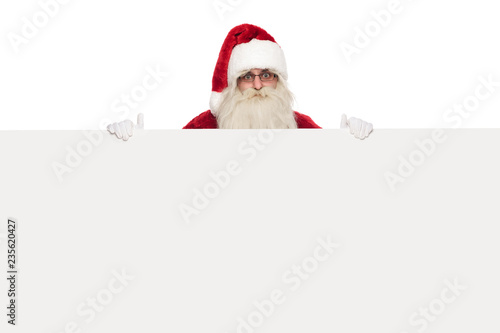 saint nick wearing sunglasses and santa costume holds white billboard