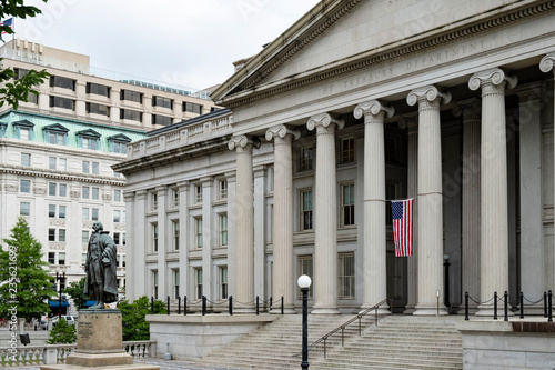 Washington DC, June 2017 United States: neoclassical style building of treasury department with Albert Gallatin statue in front of the northern entrance photo