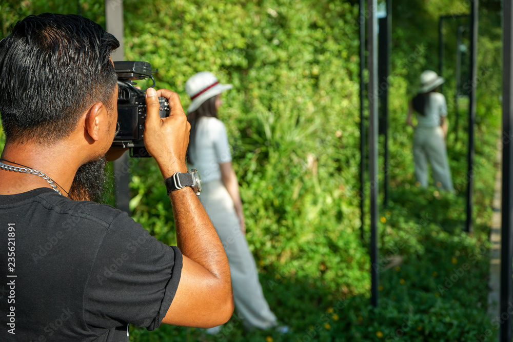 Portrait of unidentified man taking the pictuce by camera with blurred landscape in background Portrait of unidentified man taking the pictuce by camera with blurred landscape in background