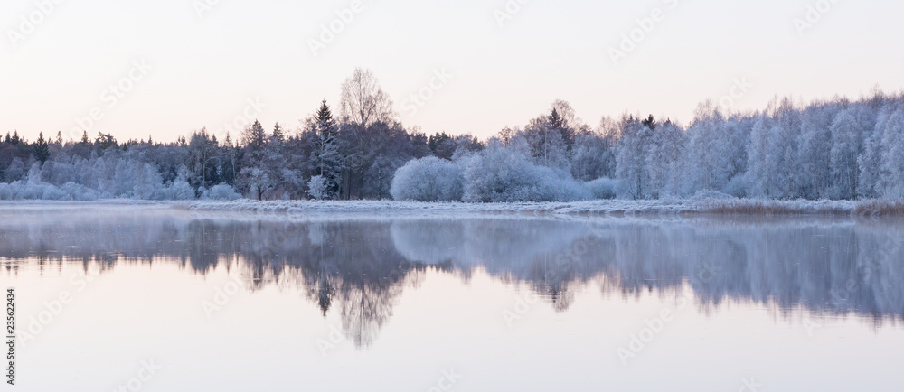 Fototapeta premium Frosty river landscape in sunrise