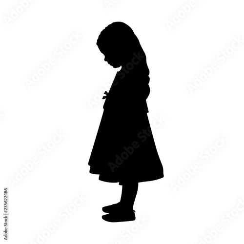 Little girl in a long dress looking down, silhouette
