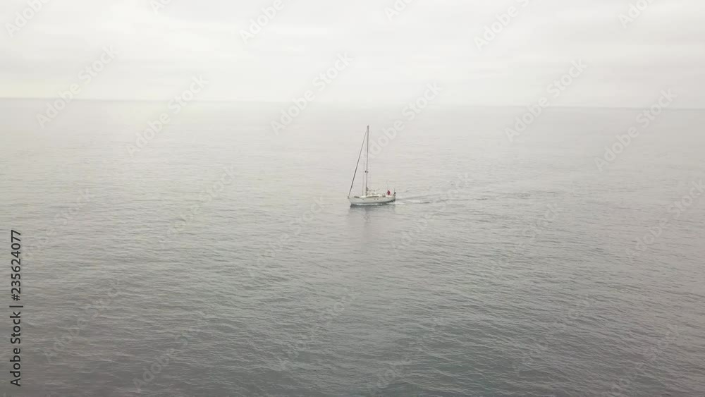 View from above flying drone yacht sailing in sea and cloudy sky on horizon View from above flying drone yacht sailing in sea and cloudy sky on horizon