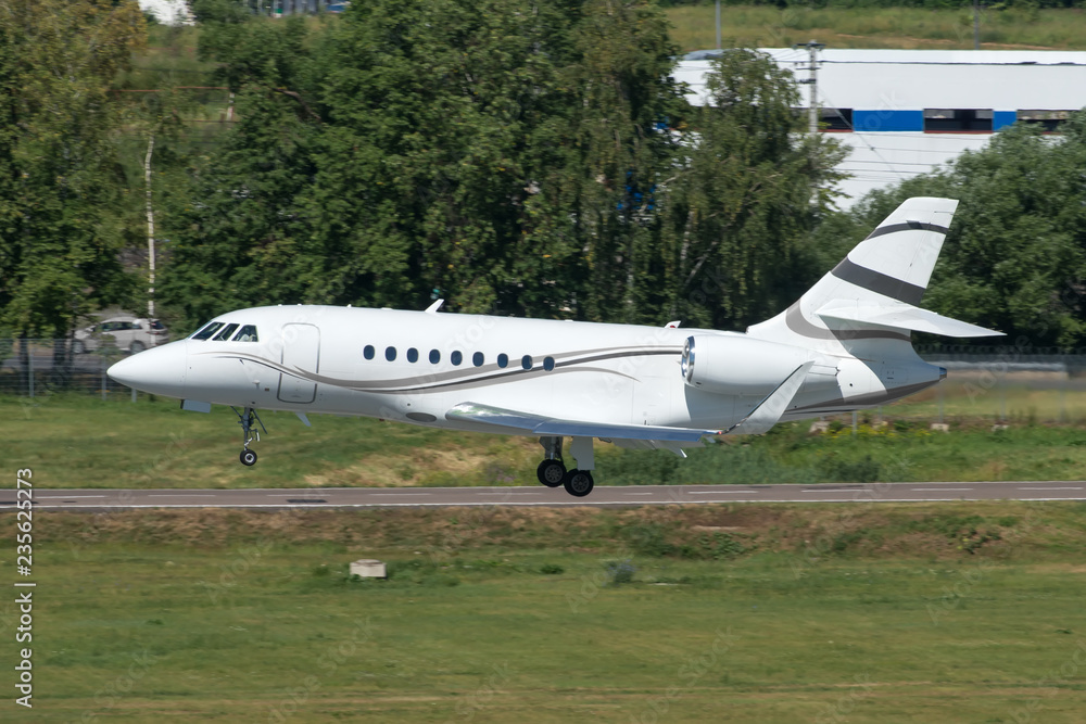 White modern private jet landing at airport White modern private jet landing at airport